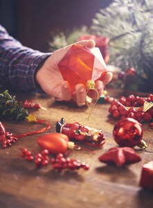 s hands holding decorations and baubles