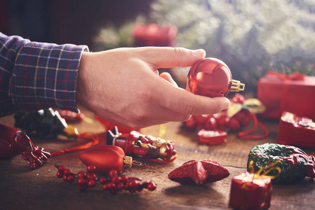 s hands holding decorations and baubles