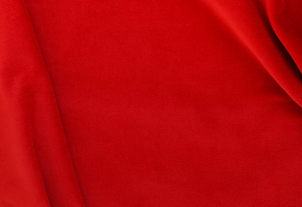 天鹅绒质地背景红色。 圣诞节喜庆的游乐场。 昂贵的豪华面料材料布。复制空间。