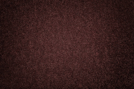 黑褐色哑光背景的绒面织物特写.