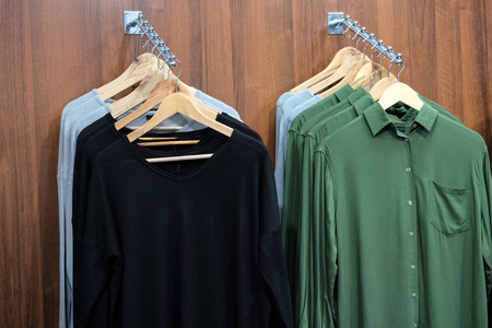 s clothing on wooden hangers in a fashion store. The concept of 