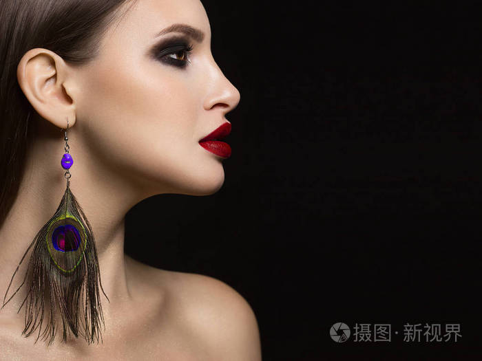 特写一幅美丽的肖像,她有着华丽的面部特征,突出了红色口红和黑色烟熏