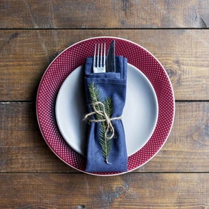 s serving plate, gray plate on red plate, with fork and knife an