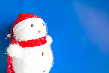  snow man with a red hat and red scarf on blue background with c