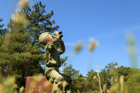  Happy child In a helmet with glasses and binoculars, playing wi