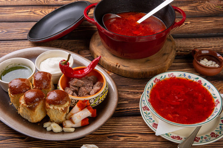 传统的乌克兰罗宋汤。 罗宋汤潘。 博尔施新鲜乌克兰红。 满锅美味的红色罗施与铲子。 传统的乌克兰菜，含肥肉，潘普什卡，酸奶，大蒜