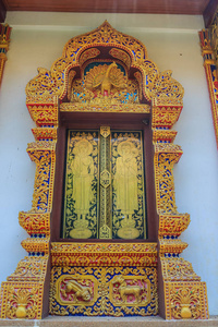 s style temple windows with golden craved buddha on the window p