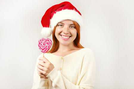  white knitted sweater holding round lollipop. Cute female celeb