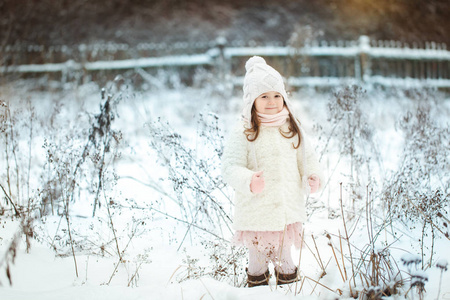 冬天森林里穿着白色皮大衣的小女孩