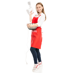 一个穿着红色围裙的女人拿在厨房的搅拌机手里拿着碗