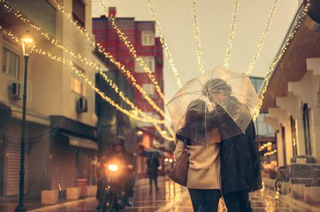 朋友走在街上黑色下隔雨下情侣接吻的侧面观察情侣在雨中接吻的热像在