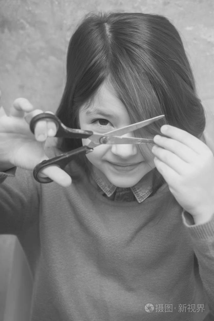 漂亮的女孩用剪刀剪头发照片-正版商用图片14owtd-摄图新视界