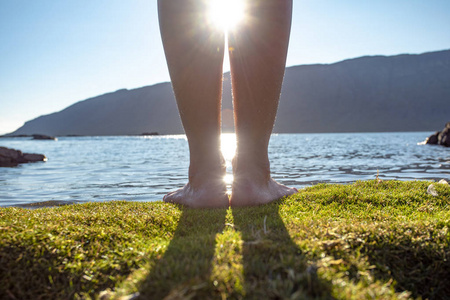 s legs in the water in the sunlight.