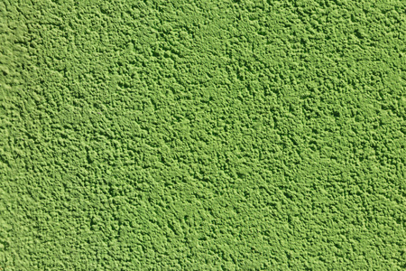 墙上装饰的绿色石膏纹理。 背景绿色灰泥墙的纹理