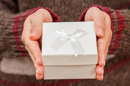 女人手里拿着礼品盒. 浅场深选择性聚焦在盒子上.