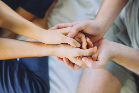 男女手床上近距离拍摄男女双手相握照片