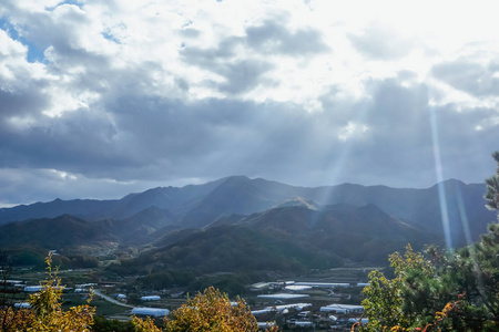 s rays from the sky and a beautiful view of the hills and mounta