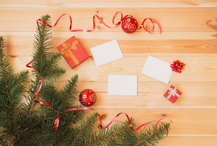 树枝，圣诞球，礼物和空卡为您的文字在木制背景。俯视图，复制空间..