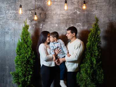 s portrait of a happy family near Christmas trees, walls and bri