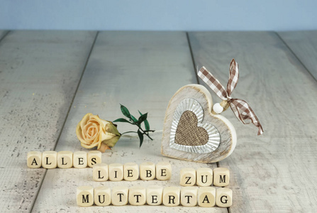 s Day in wooden letters, with a rustic wooden heart and a dry fl