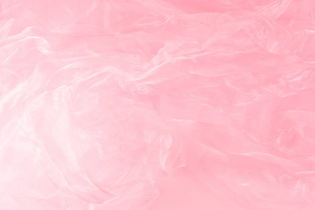 粉红色皱褶和透明织物背景