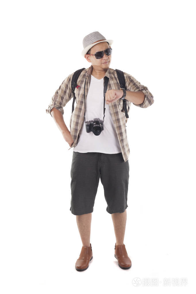 全身肖像. 看着他的手表等待在线出租车运输接送照片-正版商