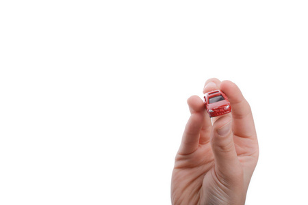 s hand holding a red car on a white background