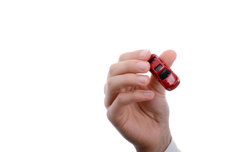 s hand holding a red car on a white background