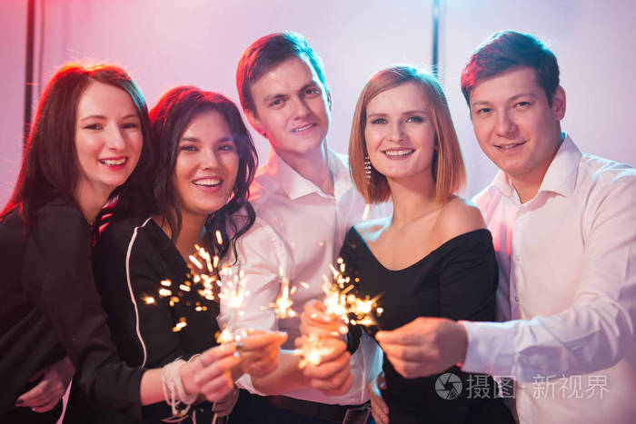 新年聚会庆祝和节日概念青年开朗的男人和女人拿着燃烧的火花