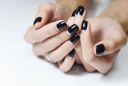 s hand with black manicure nails