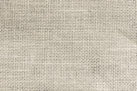老式抽象黑纱或麻布织物或麻袋纹理背景。 艺术威尔士亚麻布帆布的奶油壁纸。 棉布图案的毯子或窗帘，有文字装饰的复制空间。