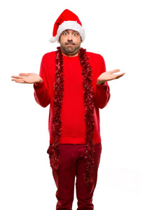 穿着红色衣服庆祝圣诞节的男人，在孤立的白色背景上举起双手和肩膀时，有疑虑