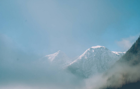 白雪覆盖的白色山顶。奥地利阿尔卑斯山浓雾弥漫.老式颜色