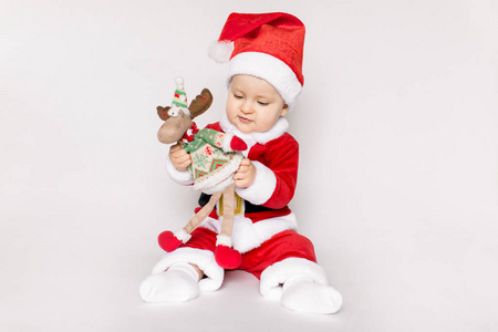 s holidays. Baby in a Christmas costume with gift