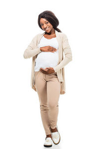 满脸笑容的怀孕非洲裔美国妇女摸着被隔离在白色上的腹部