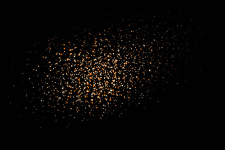 金色闪光爆炸。溅出金色颗粒..在黑色背景上分离的抽象纹理