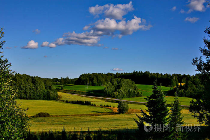 这个国家美丽而温暖的夏日绿色的田野一些森林和蓝天从更高的地面拍摄