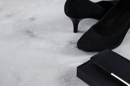 s accessories. Classic black suede shoes with high heels and sma