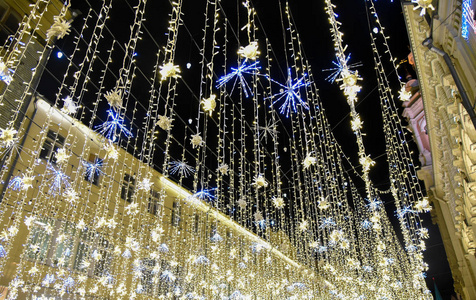 s bright Golden garland on the street in Moscow night