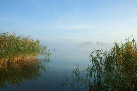 s boat in the fog. Calm autumn landscape.