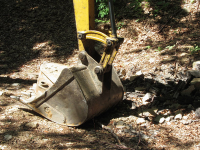 黄挖机的水桶坐在木头里休息图片