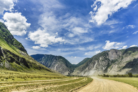 阿尔泰自然的美丽景色和景观。 阿尔泰的道路和公路的视角，背景是雄伟的山脉，覆盖着森林和天空，云层。