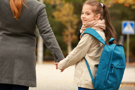 可爱的女孩和她妈妈一起去户外上学年轻夫妻送孩子去上学年轻夫妻送