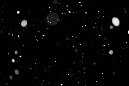 暴风雪的质地。黑色背景上的波克灯光，空中飘起的雪花