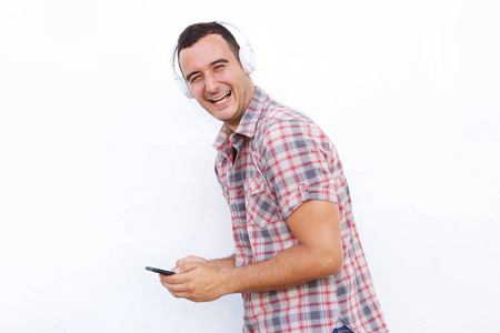 快乐男人用手机和耳机听音乐的侧面画像