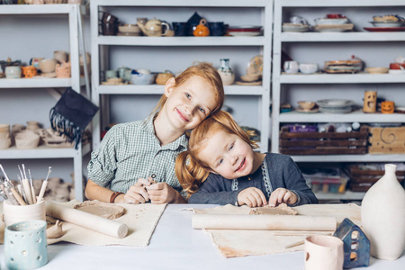 微笑着漂亮的红头发的孩子享受他们的时间在艺术工作室