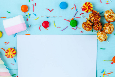 s sweets. Candies on a blue, wooden background. Copy space, swee