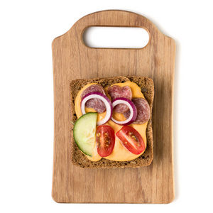 在白色背景特写上隔离的木制服务板上打开面对香肠三明治罐头或Crostini。 上面的风景。