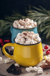 热巧克力杯，上面有棉花糖，巧克力和肉桂背景上有一根棒棒糖棒。 一个舒适的圣诞家庭假日的概念