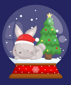 一只可爱的小兔子坐在圣诞雪球里